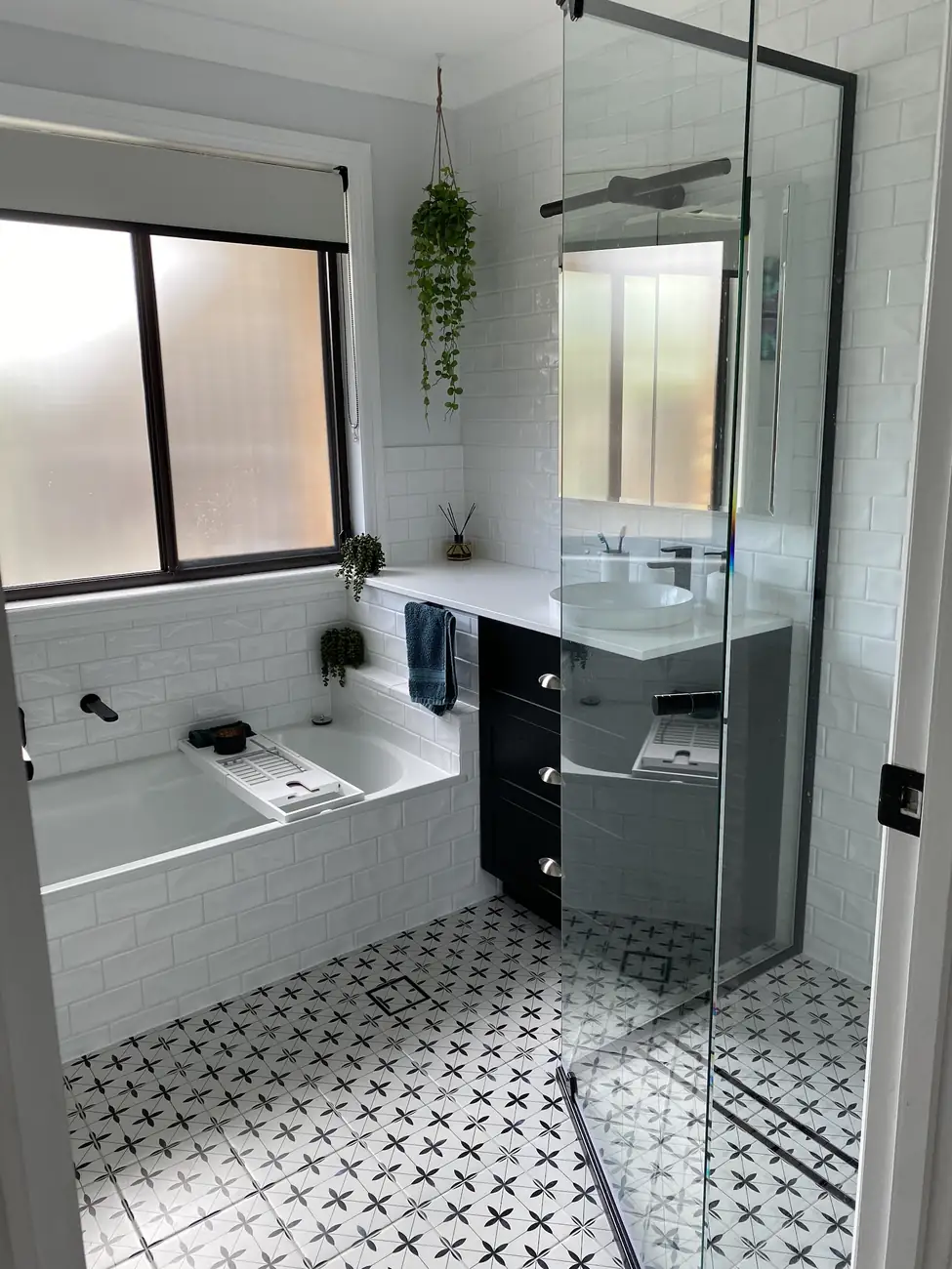 The same bathroom from the doorway, showing the shower screen and vanity